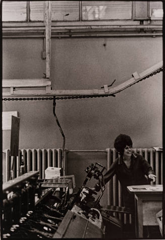 Soviet Union (female worker at desk reaching over to printing press)