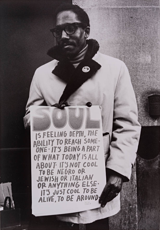 Man with Sign "SOUL is feeling depth, the ability to reach someone..."