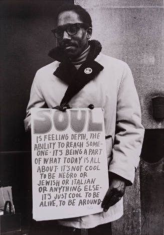 Man with Sign "SOUL is feeling depth, the ability to reach someone..."
