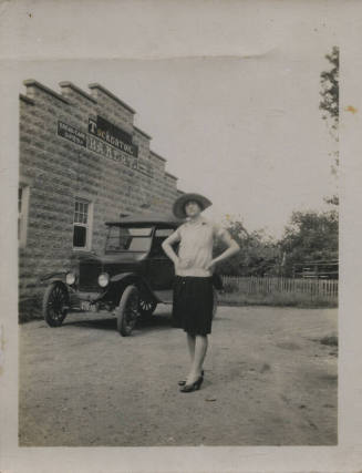 Untitled [Woman stands with hands on hips in front of Tuckerton Bakery]