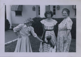Untitled [Three women in a garden, two in stripes and one in a floral dress (from left to right)]