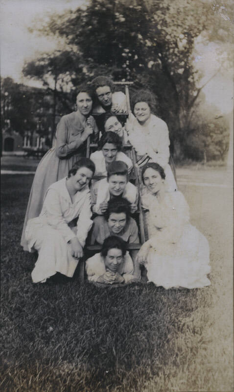 Untitled [Ten women pose with a ladder]