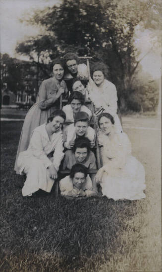 Untitled [Ten women pose with a ladder]