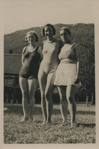 Untitled [Three women, two in bathing suits and one in a two-piece stand together, a house and mountain behind them]