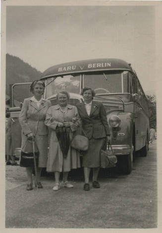 Untitled [Three women stand in front of bus that reads Baru Berlin]