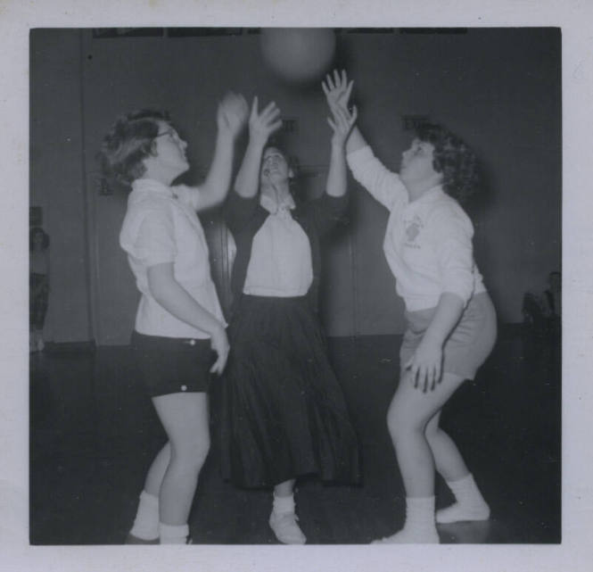 Untitled [Three women raise ball to air]