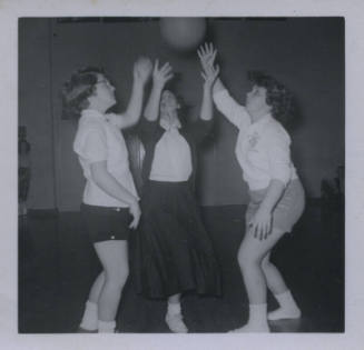 Untitled [Three women raise ball to air]