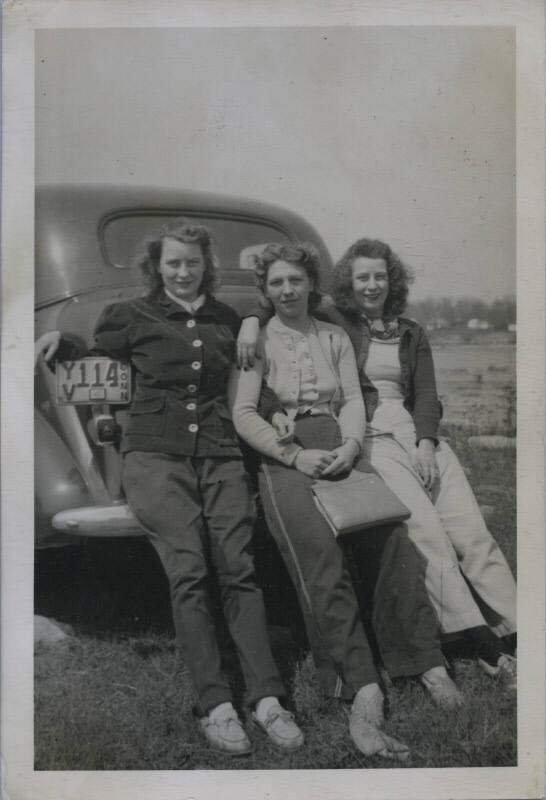Untitled [Three women sit on car's back fender, plate reads YV 114 CONN]