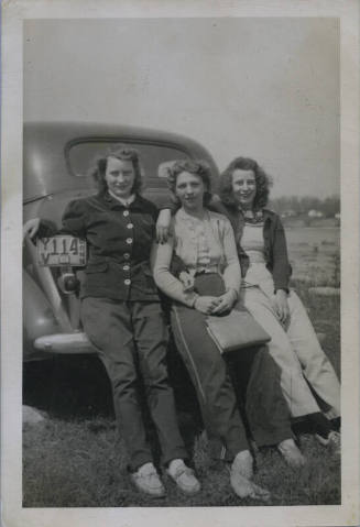 Untitled [Three women sit on car's back fender, plate reads YV 114 CONN]