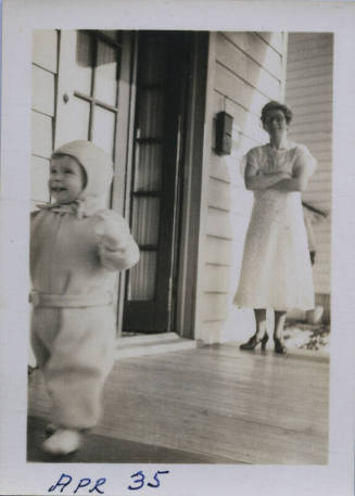Untitled [Woman crosses arms, child walks away from her]