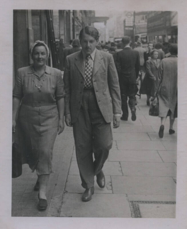 Untitled [Woman and man walk side by side on street]