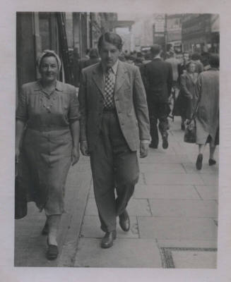 Untitled [Woman and man walk side by side on street]