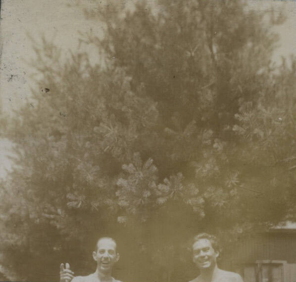 Untitled [Two mens' upper torso, man on left points towards camera]