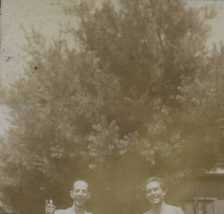 Untitled [Two mens' upper torso, man on left points towards camera]