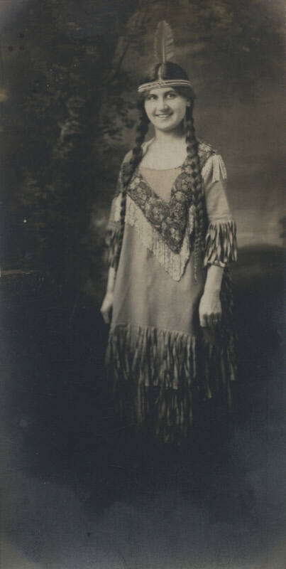 Untitled [Woman wears feather headdress]