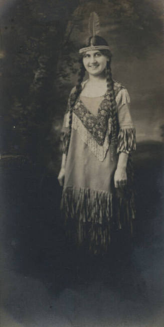 Untitled [Woman wears feather headdress]