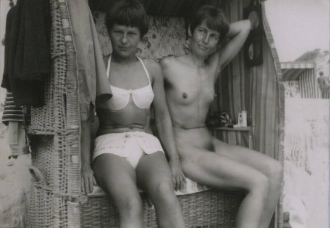Untitled [Two women sit on wicker beach]