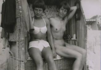 Untitled [Two women sit on wicker beach]