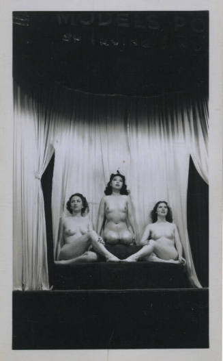 Untitled [Three women sit onstage, curtain in the background]