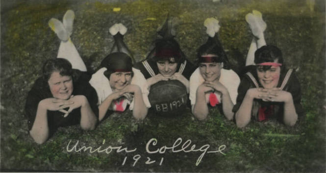 Untitled [Five women lie on lawn, woman in middle holds ball that reads BB1921]