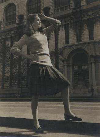 Untitled [Woman looks out, one hand on hip, one above head, places foot on curb]