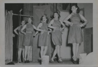 Untitled [Five women step on to stage, hands on hips]
