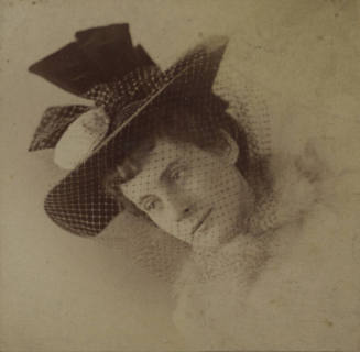 Untitled [Woman looks away from camera, wears hat and mesh veil]