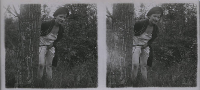Untitled [Woman stands behind tree, holds up dress (repeated horizontally)"