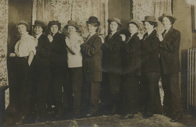 Untitled [Nine women stand in line formation, all in coats and hats]