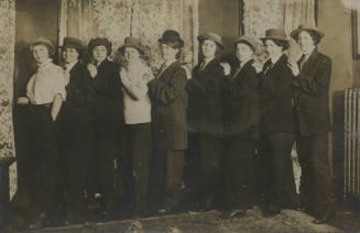 Untitled [Nine women stand in line formation, all in coats and hats]