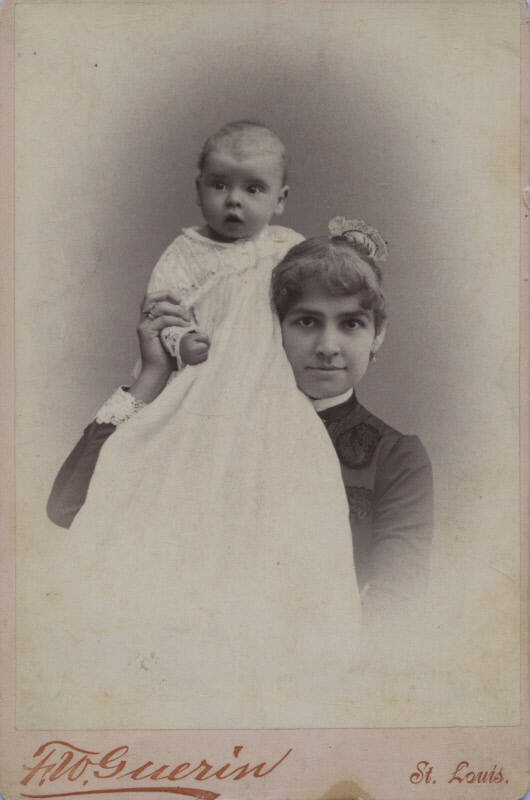 Untitled [Woman holds child on shoulder]