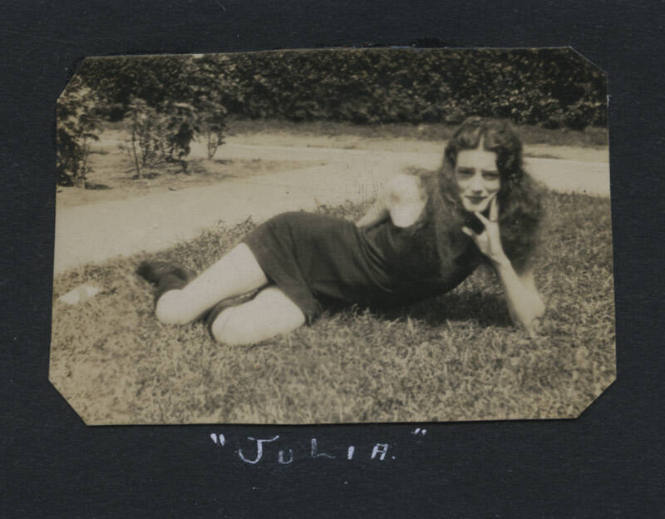 Untitled [Woman lies on lawn, rests face on hand]
