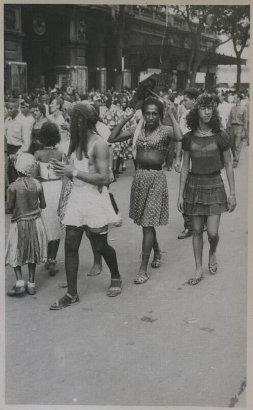 Untitled [People walk down crowded street]