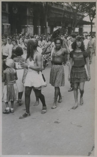 Untitled [People walk down crowded street]