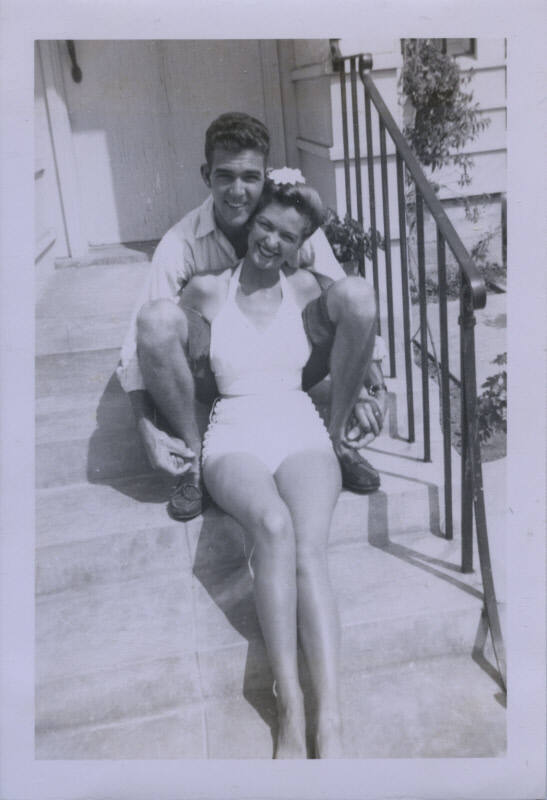Untitled [Woman and man sit on porch steps]