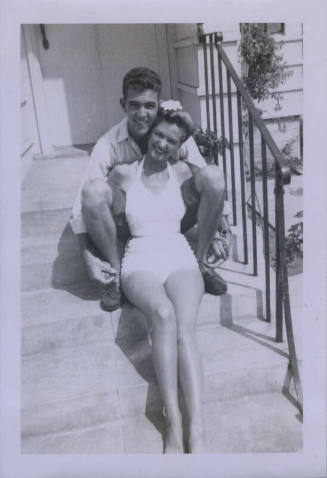 Untitled [Woman and man sit on porch steps]