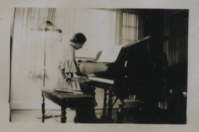 Untitled [Woman sits, plays piano]