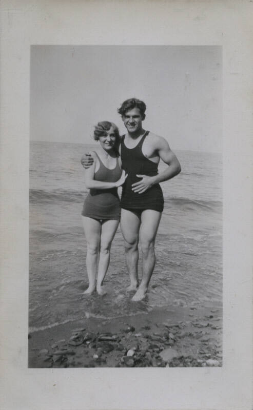 Untitled [Woman and man stand on beach]