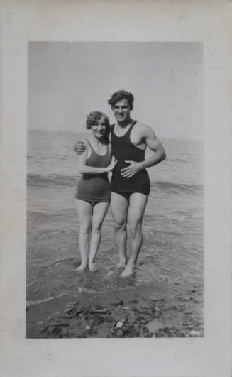 Untitled [Woman and man stand on beach]