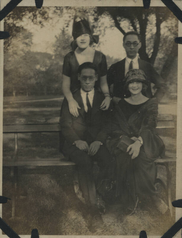 Untitled [Two women and two men sitting on park bench]