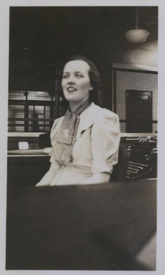 Untitled [Woman sits, looks away, wears scarf]