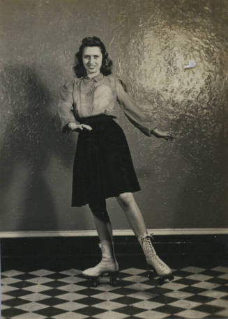Untitled [Woman stands, hands to one side, wears roller skates]