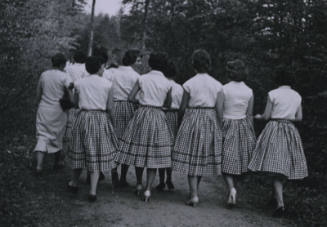 Untitled [Ten women walk in woods, wear checkered skirts]