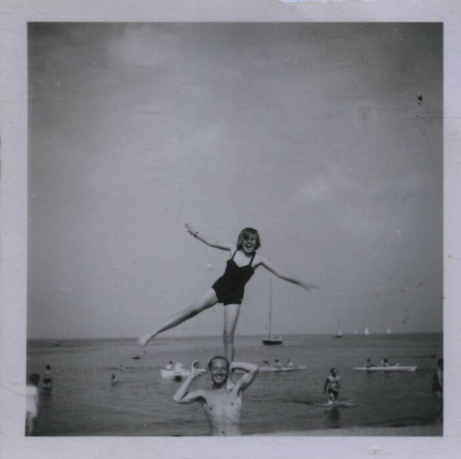 Untitled [Woman stands on one leg upon man's shoulder]
