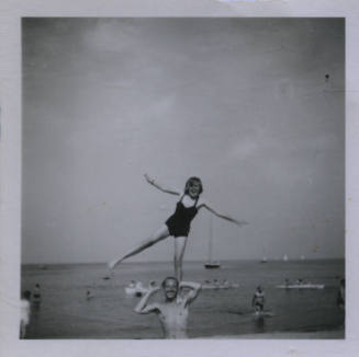 Untitled [Woman stands on one leg upon man's shoulder]