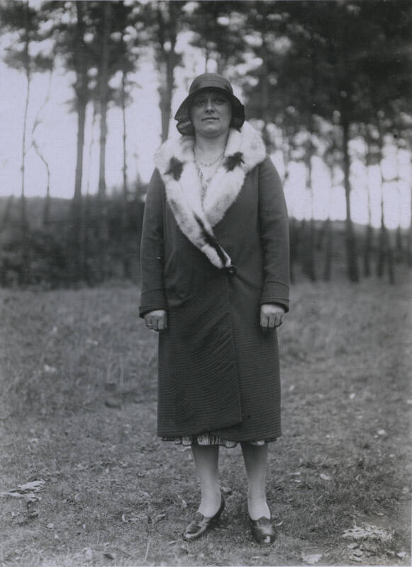 Untitled [Woman stands on field, hands by her sides]