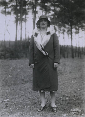 Untitled [Woman stands on field, hands by her sides]