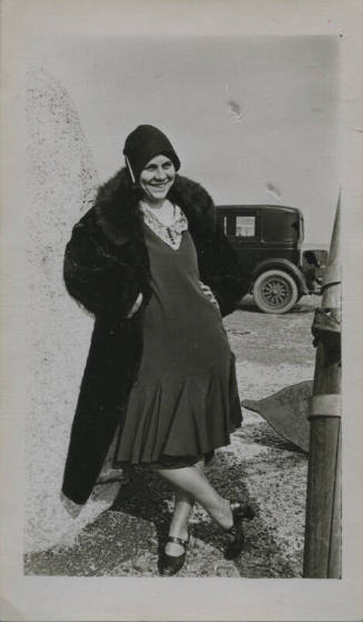 Untitled [Woman stands, hands on hips, legs crossed]
