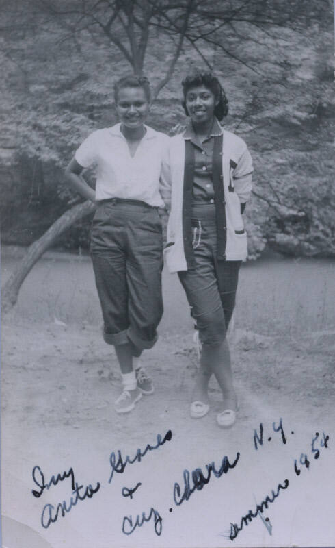 Untitled [Two women stand on field]