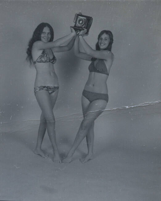 Untitled [Two women hold up camera]